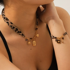 Leopard print fabric necklace and bracelet set with golden sun and heart charms