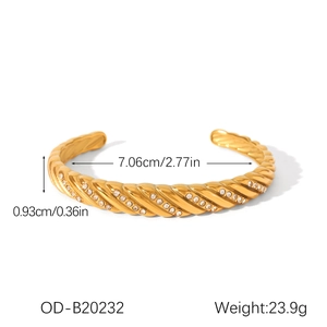 Detail view of gold twisted bangle with clear zircon stones showing 7.06cm inner diameter