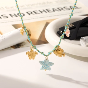 Braided ocean necklace with gold turtle and ceramic starfish charms on light blue cord