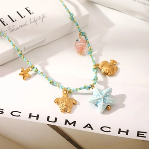 Braided ocean theme necklace with golden starfish, turtle, and fish pendants in summer style