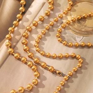Detailed view of polished 18K gold-plated stainless steel bead chain necklace for women