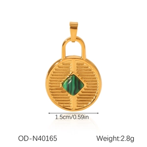 Detail of 18K gold stainless steel sun pendant featuring a green malachite stone inlay