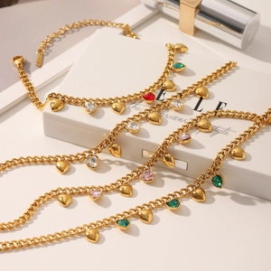 Vista de detalle de colgantes de corazón con circón en cadenas de acero inoxidable dorado
