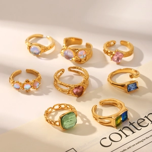 Detail shot of vintage gold adjustable rings with moonstone and colorful gemstones