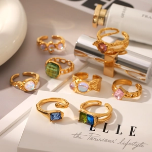 Detailed close-up of vintage gold rings with irregular textures and colorful gemstones