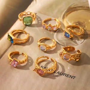Set of vintage adjustable gold rings with colorful emerald and sapphire stones