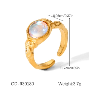 Detailed view of the moonstone ring with irregular hammered texture and gold finish