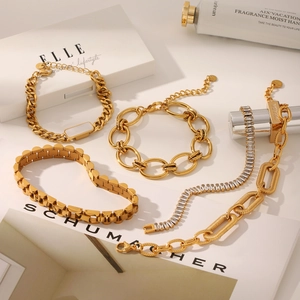 Detail of four 18K gold plated stainless steel bracelets with zirconia accents