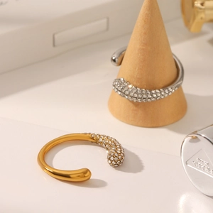 Macro view of C-shaped open ring with cubic zirconia micro-pave and polished finish
