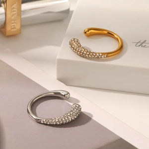 Macro shot of minimalist gold and silver ear cuffs with pavé-set sparkling crystals
