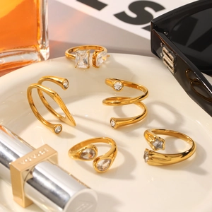 Detailed view of irregular gold-plated stainless steel rings with sparkling zircons