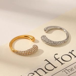 Close-up of gold and silver open rings featuring micro-pave crystals and polished finish