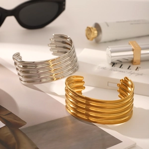 Classic minimalist stainless steel wide cuff bangle with parallel grooved design in gold and silver