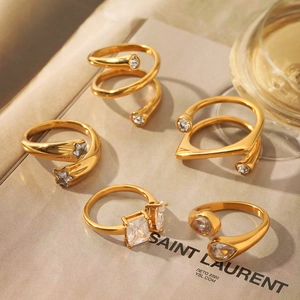 Detail view of five gold-plated irregular rings set with sparkling zirconia crystals