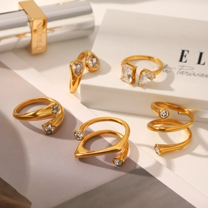 Detailed view of assorted gold plated irregular rings with sparkling zircon inlay details