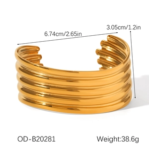 Detailed view of wide gold cuff bracelet featuring a five-layer wavy ribbed design