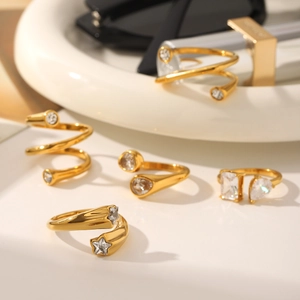 Chic gold-plated stainless steel rings with sparkling cubic zirconia on a white tray