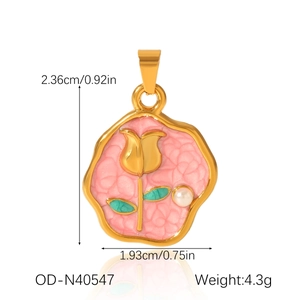 Macro view of pink enamel tulip pendant with golden petals and a white pearl accent