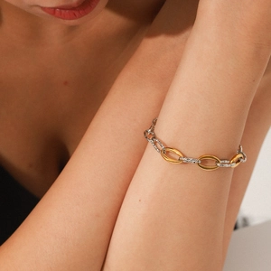 Detailed shot of two-tone gold and silver stainless steel chain with textured oval links