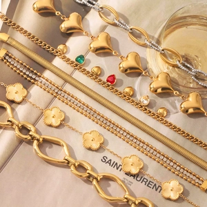 18K gold-plated stainless steel jewelry set featuring heart and floral charms on flat lay
