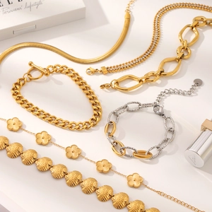 Golden and silver stainless steel layered bracelets and necklaces with floral charms
