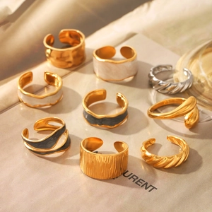 Collection of golden drip oil rings and hammered metal bands on a magazine page