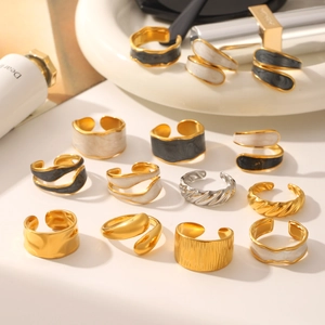 Golden stainless steel rings set featuring enamel drip oil designs and textured bands