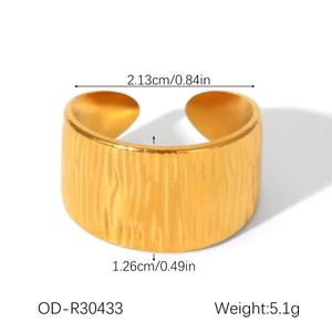 Detail view of golden stainless steel wide ring showing dimensions and striped texture