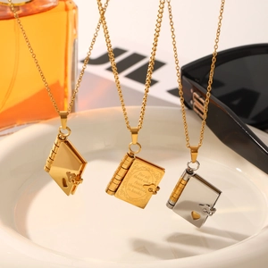 Romantic book-shaped pendant necklaces in gold and silver stainless steel with heart detail