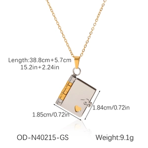 Detail of book-shaped titanium steel pendant with golden heart and silver finish