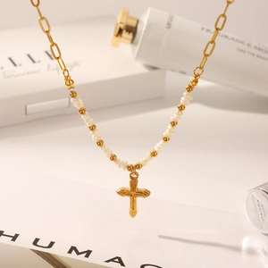 Elegant gold cross pendant necklace with pearls and paperclip chain style for women