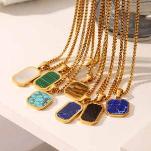 Macro view of gold box chain necklaces featuring colorful octagonal stone pendants