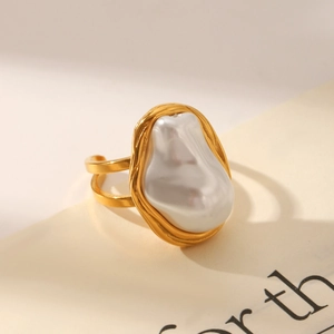 Detailed macro view of baroque pearl on a gold-plated adjustable double-layer ring