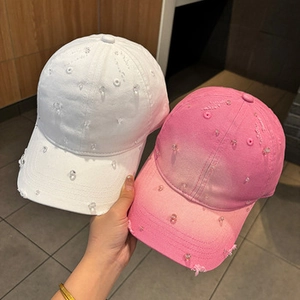 Close-up of holographic PU baseball caps with distressed details and shimmering sequins