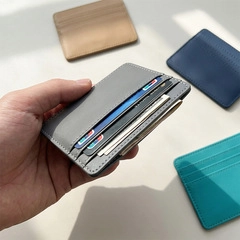 Detail of slim PU leather card holder showing multiple slots and grey finish