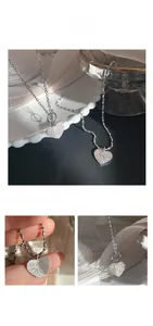 Detail of 925 silver heart pendant with frosted sand texture and OT toggle clasp