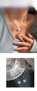 Detail of 925 silver heart necklace with shimmering zircon inlay and trendy OT buckle
