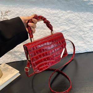 Deep red crocodile pattern small square bag with pleated ring handle and gold hardware