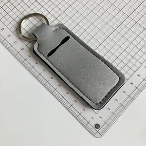 Close-up of neoprene leopard print lipstick holder keychain with a sturdy metal ring