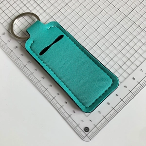 Detail of mint green neoprene lipstick holder keychain with silver ring and stitching