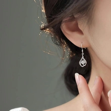 Close-up of elegant 925 silver water drop earrings with zircon on a female model