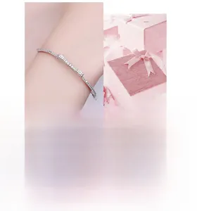 Close-up of silver bow bracelet with pavé cubic zirconia displayed in a gift box