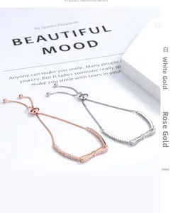 Detail of adjustable bow-knot bracelet in white gold and rose gold with zircon stones