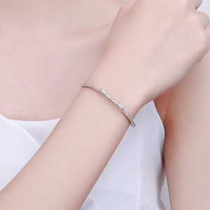 Elegant 925 sterling silver bow bracelet with zircons shown on a female wrist