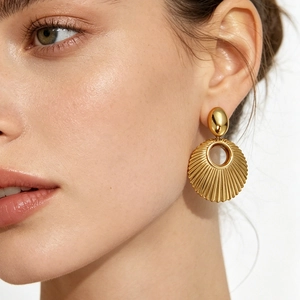 Vintage gold-plated titanium steel earrings with creative shell pattern and circular pendant
