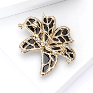 Elegant lily flower brooch with gold alloy frame and black enamel, back view details
