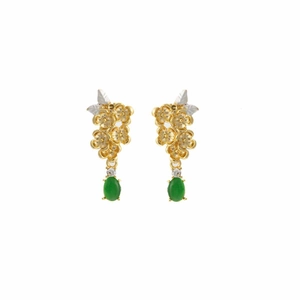 Detail of vintage teardrop earrings with gold flowers and green jade stone drops
