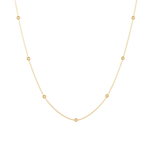 Minimalist gold snake chain necklace with small round beads on a clean white background