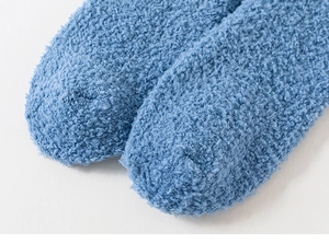 Dettaglio macro di calze in pile corallo blu che mostrano la consistenza morbida e calda