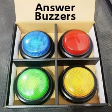 Set of four colorful interactive answer buzzers in a black organizer tray for kids